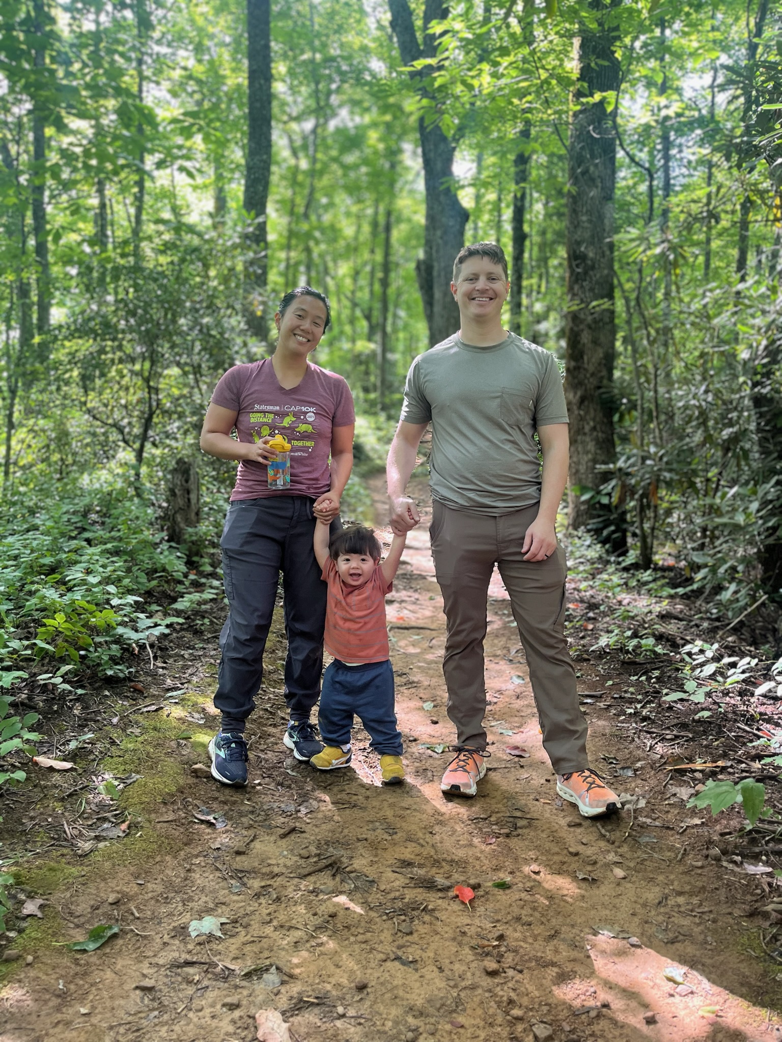 Ryan Schmidt with his family hiking in the woods